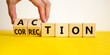 Action or correction symbol. Businessman turns wooden cubes and changes the word correction to action. Beautiful yellow table, white background, copy space. Business and action or correction concept.