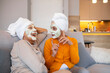 © Dragana Gordic - Smiling mature women with facial masks on their faces. Women with facial masks and cucumber slices. Women taking good care of their skin. Female Friends With Face Packs