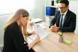 © AntonioDiaz - Attractive HR manager hiring and giving a contract to a woman