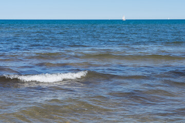 view of the blue sea and sailing boat