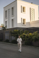 Poster - Vertical shot of a tattoed stylish man walking outdoors