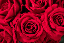 Closeup Of A Bouquet Of Red Artificial Roses Under The Lights