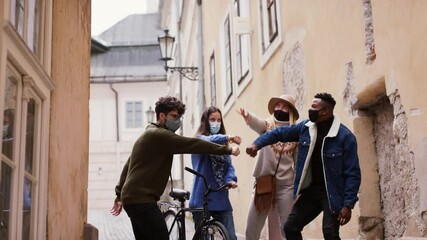 Wall Mural - Group of young people outdoors in town, greeting. Coronavirus concept.