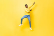 © Atstock Productions - Young cheerful energetic African man jumping and pointing hands up isolated on yellow studio background