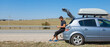© aaalll3110 - the guy looks for the road in the navigator on the phone. the tourist stopped on the road. open car trunk. travel by car