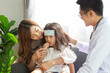 © DG PhotoStock - Asian Mother takes her sick young daughter to see a doctor in hospital
