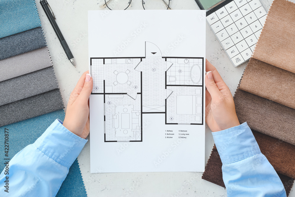 Female interior designer with house plan in office