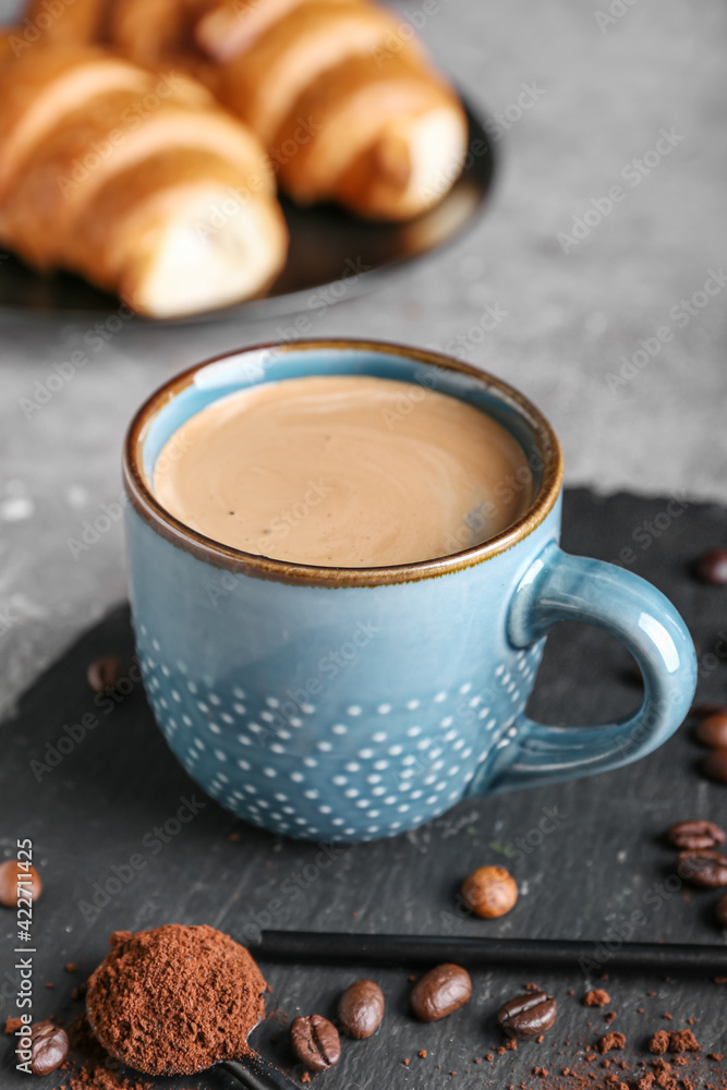 Cup of tasty hot coffee on grunge background
