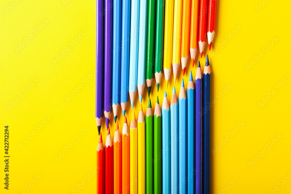 Set of colorful pencils on color background
