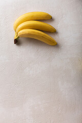 Wall Mural - Branch of ripe bananas on light background