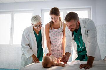 Wall Mural - Beautiful mother and baby on medical examination with doctor in hospital