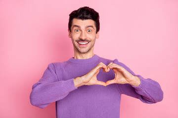 Poster - Portrait of attractive cheerful amorous guy showing heart symbol sign isolated over pink pastel color background