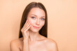 © deagreez - Photo of young attractive girl apply cream silky soft perfect skin isolated over beige color background
