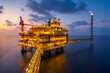 © TONTOXIN - Sunset at Offshore production platform in petroleum industry