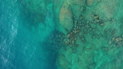 Wall Mural - waves and azure water as a background. view from drone at the ocean surface. natural summer seascape