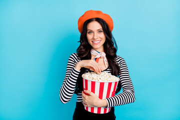 Poster - Photo of charming lady hands hold popcorn have good mood look camera isolated on blue color background