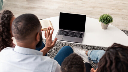 Wall Mural - Black family having videocall using pc with empty screen