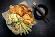 Flat lay of Japanese vegetable tempura recipe with ginger ponzu sauce , black background with copy space, no people