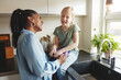 © Flamingo Images - Mom and her little daughter laughing in their kitchen