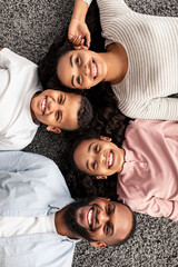 Wall Mural - Portrait of black family lying on floor together