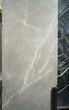Exhibitor of porcelain stoneware for pavements, store of ceramic materials for construction. Gray porcelain stoneware.