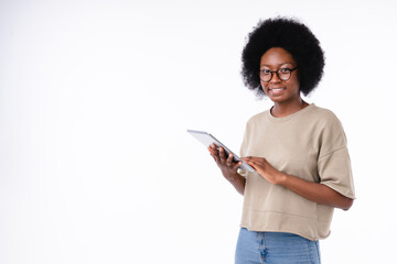 Confident cheerful african-american girl using tablet isolated over white background