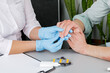 A dermatologist wearing gloves examines the skin of a sick patient. Examination and diagnosis of skin diseases-allergies, psoriasis, eczema, dermatitis