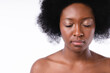 Cropped close up image of an afro girl shirtless with clean skin isolated in white background
