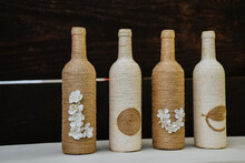 Row Of Bottle Crafts Wrapped With Jute Twine With The Word LOVE- Beautiful Rustic Decoration