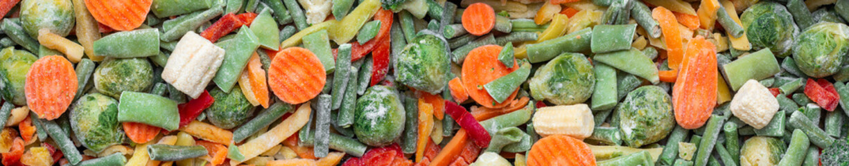 Banner. Background of a mix of frozen vegetables. Carrots, Brussels sprouts, string beans, peppers, corn. Health care, vegetarian concept, fast and healthy