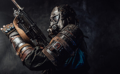 Wall Mural - Grimy hunter with gas mask and custom gun in dark background