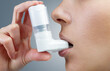 © Alex Photo - Close-up of woman using medical inhaler to prevent an asthma attack.