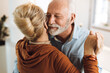© Goran - Close up of a happy mature couple having fun while dancing at home