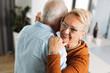 © Goran - Happy mature couple having fun while dancing at home