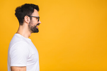 Caucasian bearded man in casual and glasses isolated on yellow background side profile view face, copy space for advertisement text, services promotion, motivated wise thoughts concept