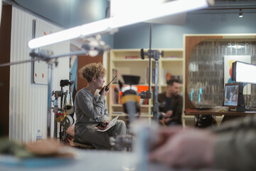 Director at work on the set. The director works with a group or with a playback while filming a movie