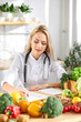 © Roman - Female doctor nutritionist writing case history in officem dietitian prescribing recipe