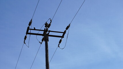 electrical line pole against sky background