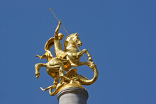Gold Sculpture Of St. George Slaying A Dragon Atop A Column In Freedom Square, Tbilisi, Georgia