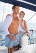 © JackF - Cheerful couple steering yacht in calm blue sea along Spanish coast during romantic summer vacation