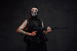 © Fxquadro - Female soldier poses in dark background holding assault rifle