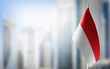Wall Mural - A small flag of Indonesia on the background of a blurred background