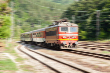 Old passenger train with motion blur effect. Railway transportation