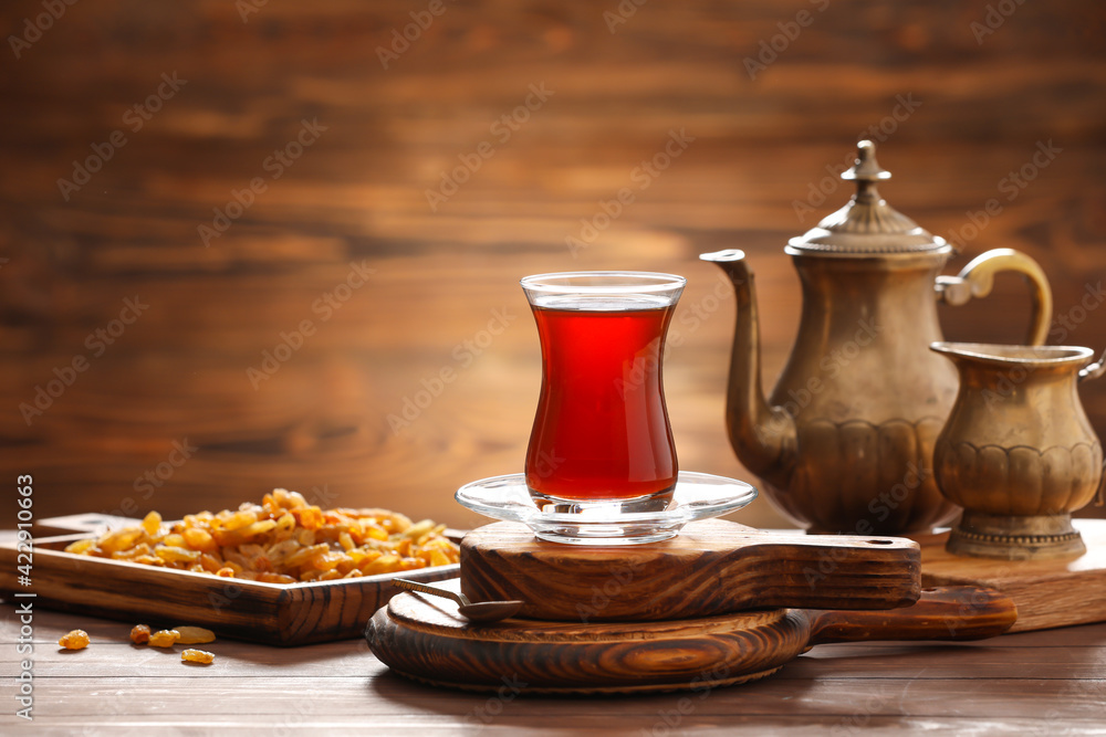 Cup with hot Turkish tea on wooden background