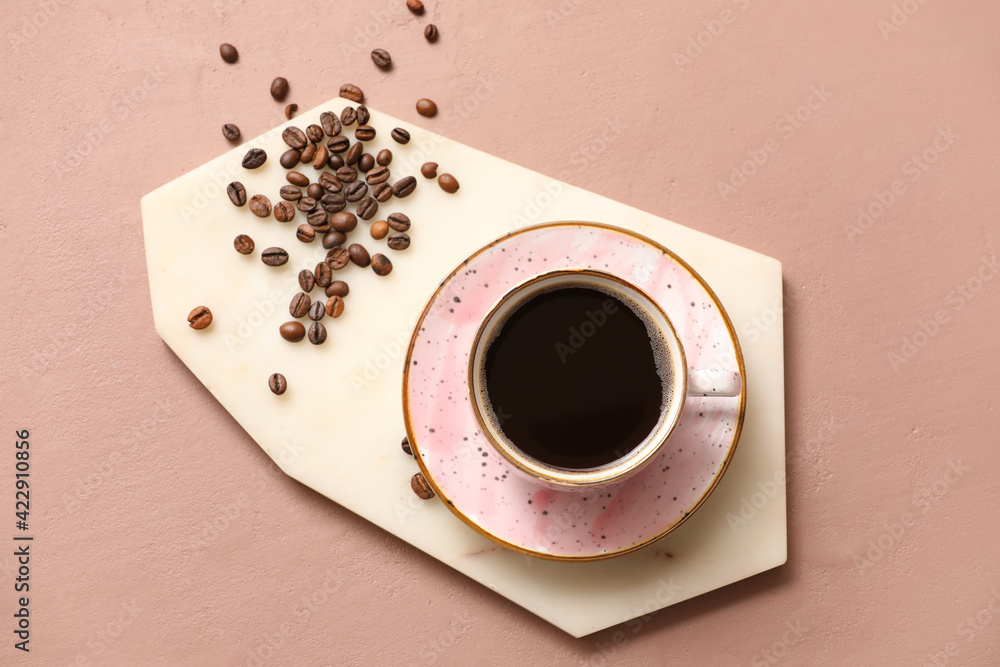 Cup of hot coffee on color background