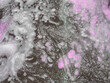 Colorful white bath foam with bubbles on the ground. Effect of space and galaxy. Abstract art. Beautiful pink soap background with waves and foam. Washing suds texture on the dark surface