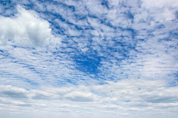 Rectangular landscape with blue sky and clouds.