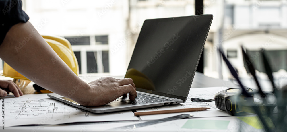 Professional home designers architects are reviewing the laptop house ...