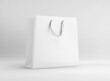 White plain paper shopping bag with ribbon handle on isolated background