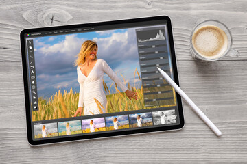 Wall Mural - Concept of digital photo editing on tablet computer with wireless stylus pen